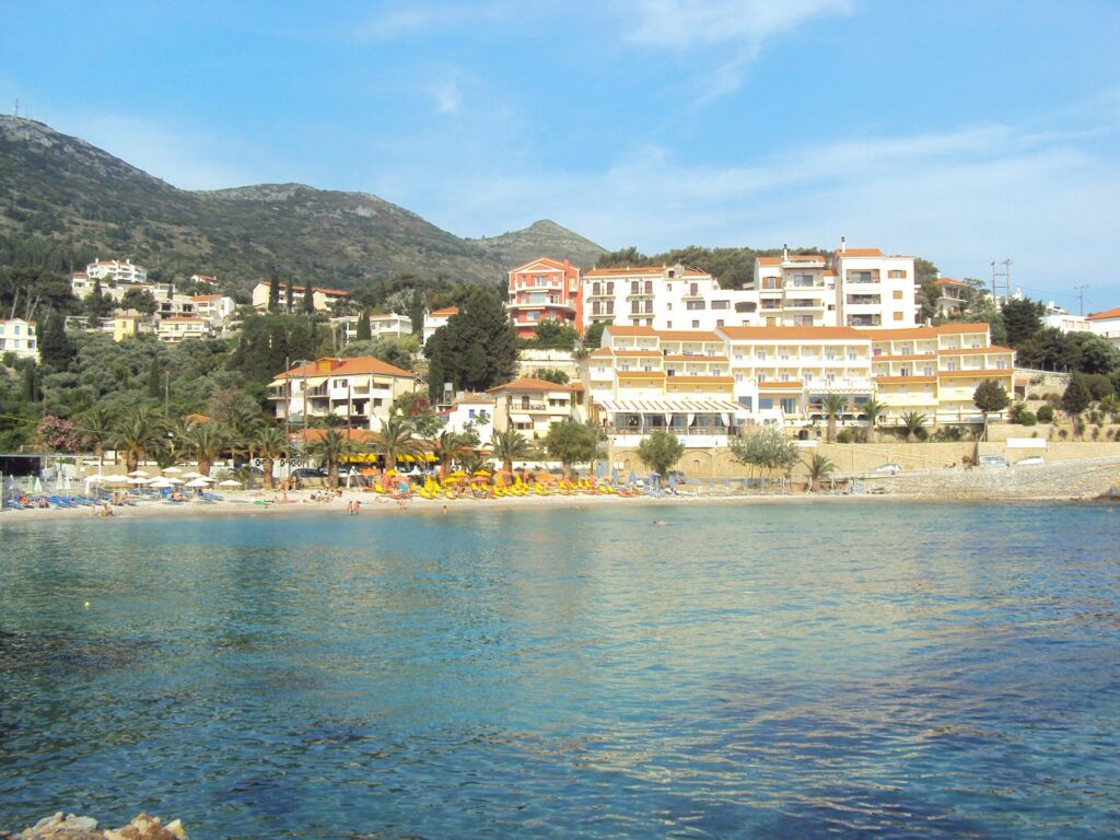 Blick über das Meer auf den Gagou Beach auf Samos. Rechts steht das ehemalige Hotel unserer Familie mit 56 Zimmern und Meerblick, links daneben unser früheres Wohnhaus. Hinter den Bäumen sind vier weitere ehemalige Familienhäuser zu sehen.